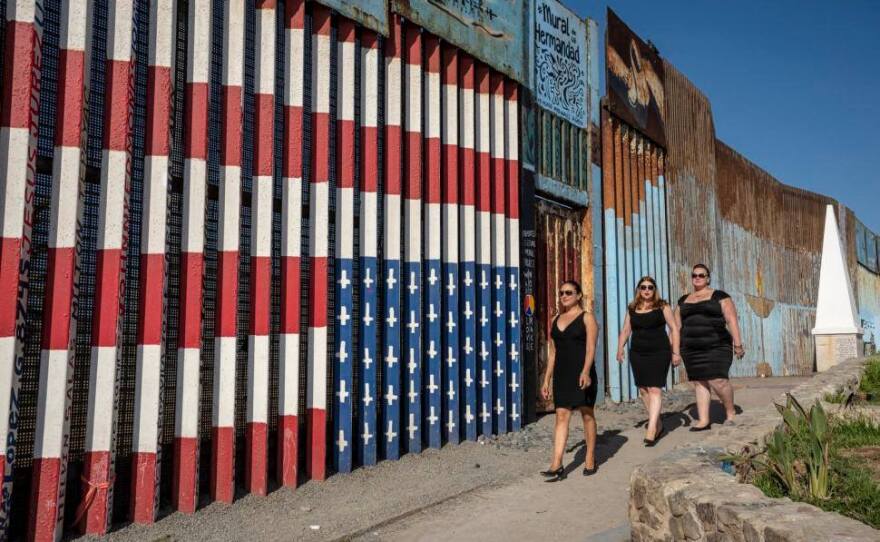 Eva Monroy, Elena Galitskaia and Anishka Lee-Skorepa walk in front of the border fence in Playas de Tijuana, October 2018.