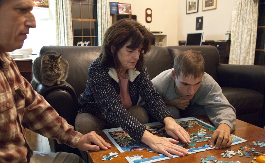 Mike Tranfaglia works on a puzzle with Katie and their son Andy. The parents started a foundation to fund research in treatments for Fragile X.