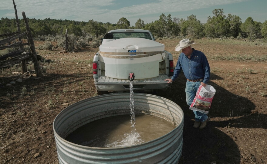 Mark Ragsdale refills a stock tank, July 17, 2026 in Redvale, Colo.