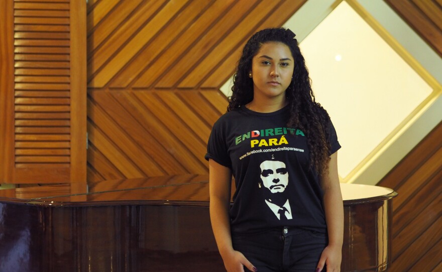 High school student Victória Marques, 18, wears a shirt emblazoned with presidential candidate Jair Bolsonaro's face in the upscale Belém hotel where a local right-wing activist group meets. People "treat us like radioactive objects," she says, "like something that can't even be looked at. I've seen people crossing the street because I'm wearing a Bolsonaro T-shirt."