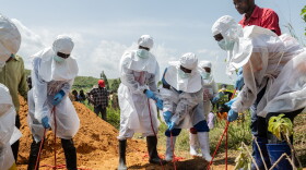 Red Cross workers bury an Ebola victim at the Rwampara Cemetery, in Rwampara, Congo, May 23, 2026.