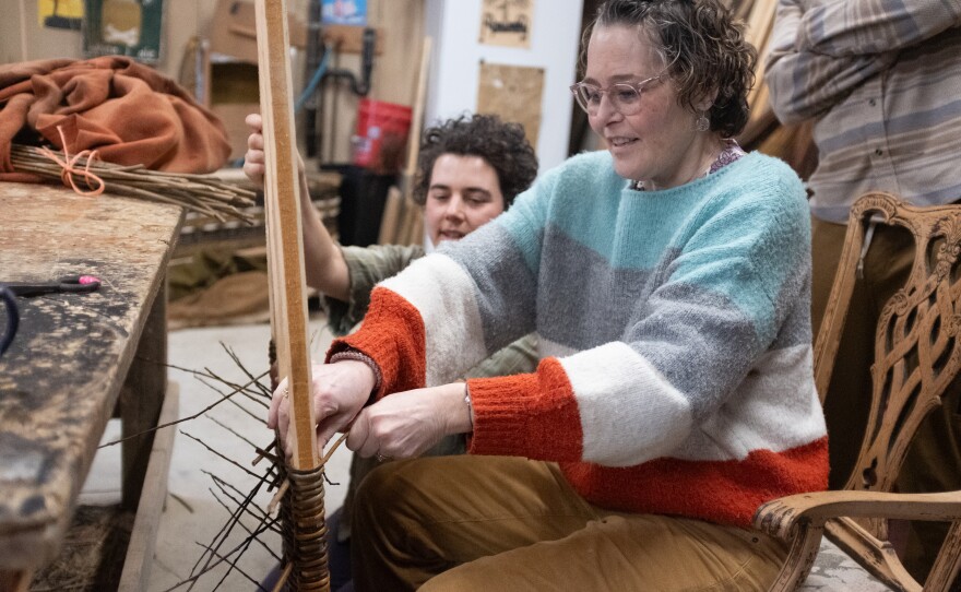 MaddyChristine Hope Brokopp volunteers to  go first in weaving a section of the back of the tray. 