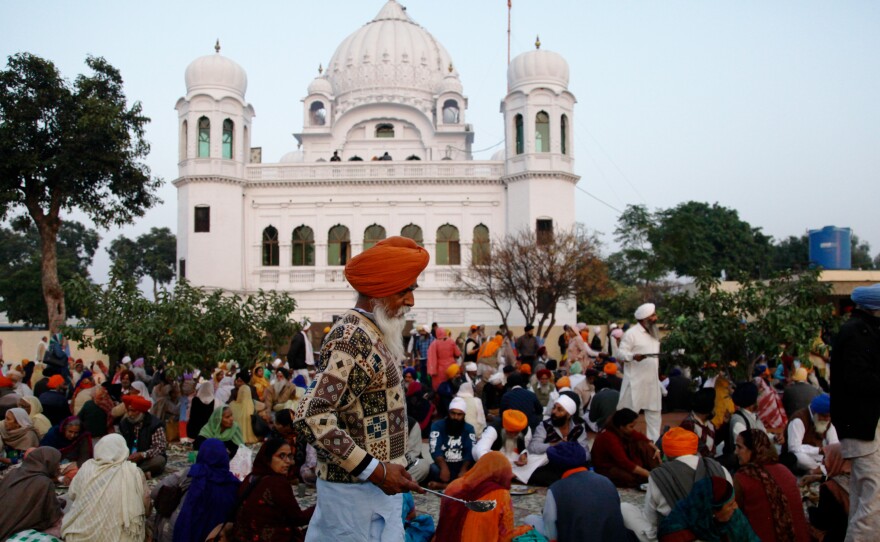 Sikh worshippers gather outside their holiest site, the Gurdwara Darbar Sahib Kartarpur. It is believed to be the place where the founder of Sikhism, Guru Nanak, died in the 16th century. In a rare goodwill gesture this week, India and Pakistan broke ground on a corridor that will allow visa-free travel for Indian Sikhs to the holy site.