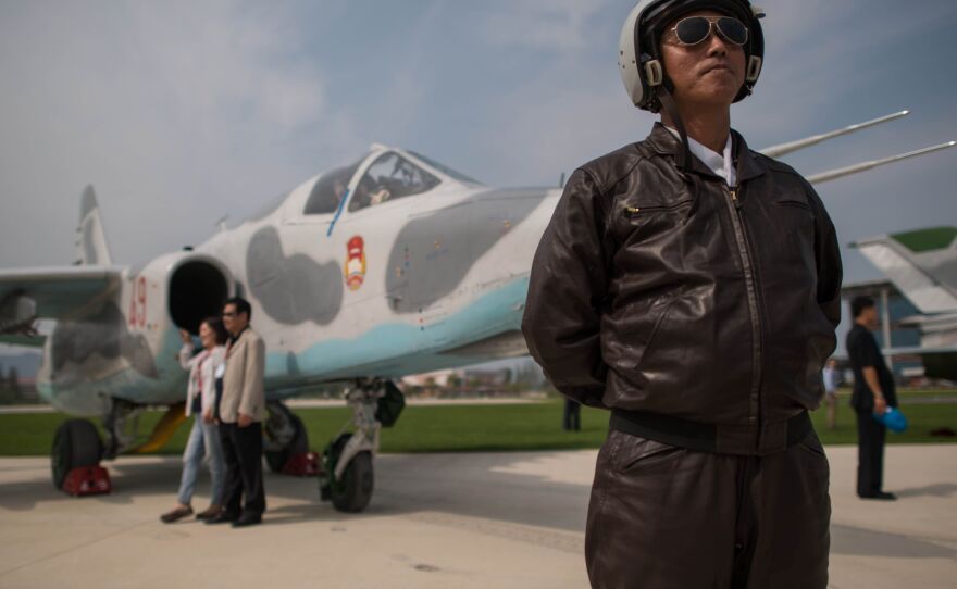 A pilot poses with a Sukhoi Su-25 aircraft during the second day of the Wonsan Friendship Air Festival in Wonsan in Sept. 2016. North Korea's air force is out-of-date, according to experts.