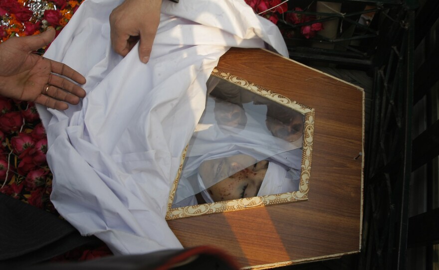 People attend a funeral of a student killed in a Taliban attack on a school in Peshawar, Pakistan, on Wednesday.