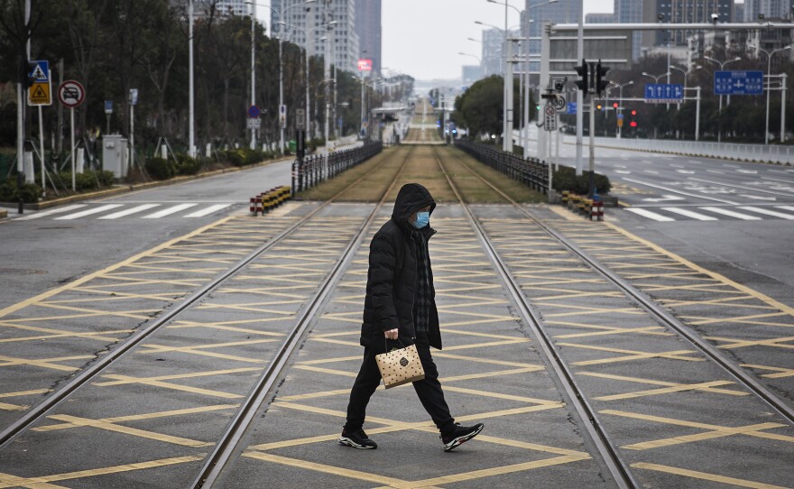 A resident walks across an empty track on Feb. 7 in Wuhan, China. Wuhan residents lived through the start of the coronavirus pandemic, which has claimed hundreds of thousands of lives around the world.
