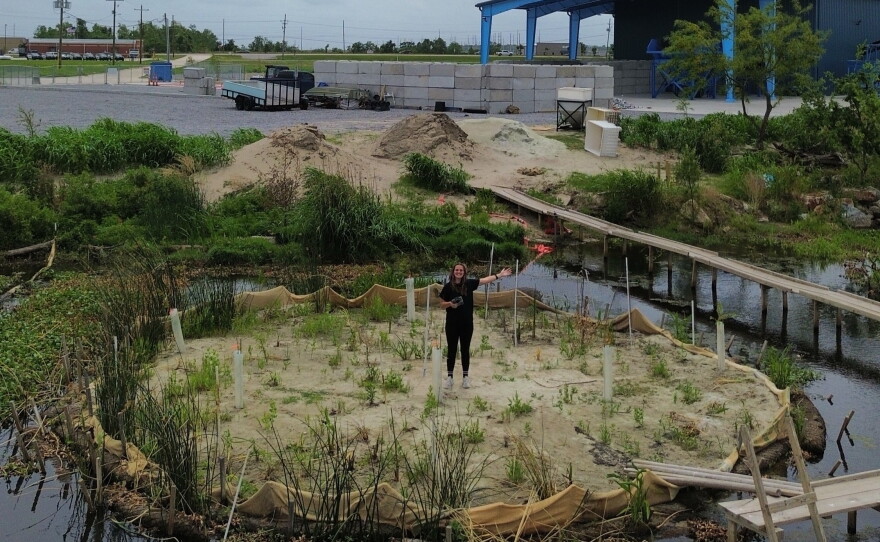 Franziska Trautmann stands on Glass Half Full's sandbank made of recycled glass.