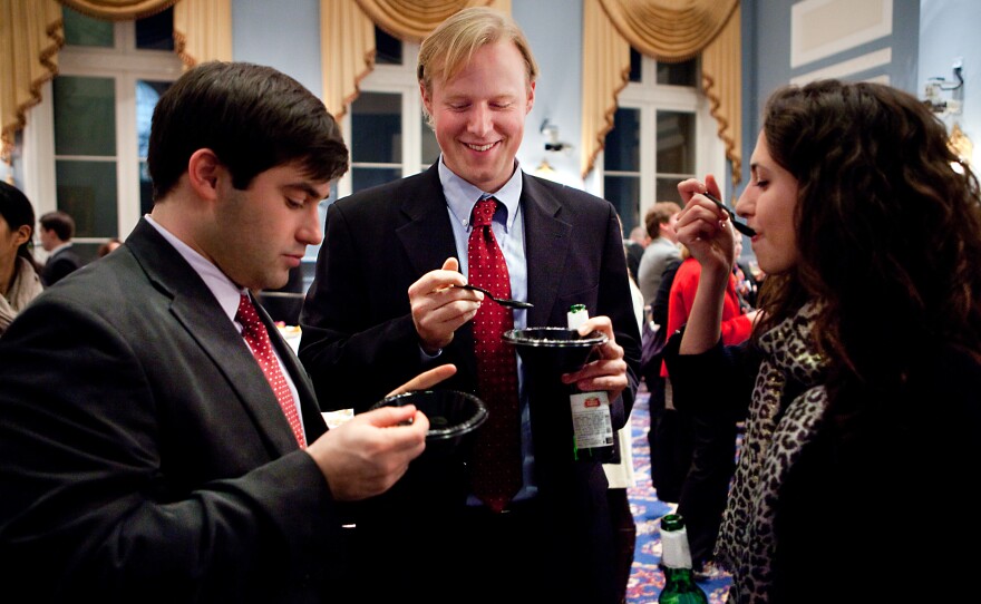 Graham Haile, left, Francis Brooke and Claire Anderson of Washington, D.C., taste test a drizzle of olive oil over vanilla ice-cream. "It doesn't taste bad," says Brooke.