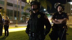 A San Diego Police officer in riot gear observes a protest Nov. 26, 2014 of a Missouri grand jury's decision not to indict a white officer who fatally shot 18-year-old Michael Brown. San Diego police kept their distance from demonstrators and no incidents were reported. 