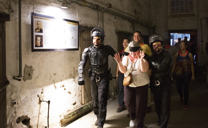 Blindfolded Sue Sawyer is escorted by the Zombie SWAT team through a cellblock as her family follows close behind. But her family will soon be prevented from going any farther. Sawyer elected to wear a glow necklace during the haunt, proving true the old saying, "You get what you pay for."