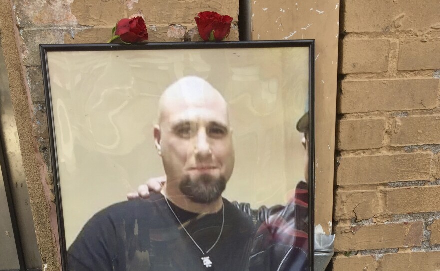 A memorial for John Elifritz, a carjacking suspect who was shot and killed by police, stands on a sidewalk in front of a Portland, Ore., homeless shelter on Monday. Groups and family members are raising questions about whether officers resorted to deadly force too quickly.