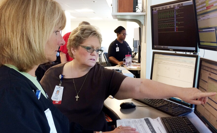Nurses Patricia Wegener (left) and Susan Davis at Mercy Hospital can monitor the condition of a patient who is miles away via the hospital's technology. But some health insurers and analysts remain skeptical that telemedicine saves money.