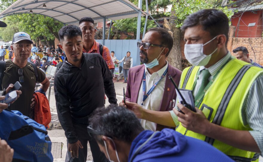 A team of climbers prepare to leave for rescue operations from the Tribhuvan International Airport in Kathmandu, Nepal, Sunday, May 29, 2022, following reports of a Tara Air flight that disappeared.