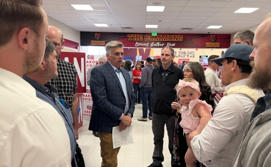 In this undated photo from the campaign, former Utah state Rep. Phil Lyman speaks with potential constituents.