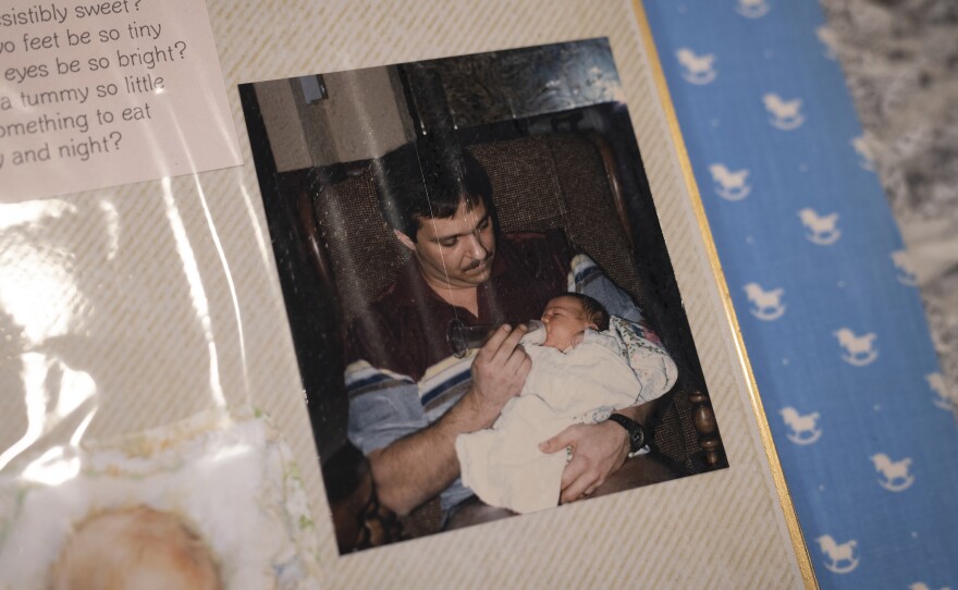 A photo of Larry Hobson holding his daughter, Heather Woock, as an infant. Woock's mother consulted with a fertility doctor when she was having trouble getting pregnant.