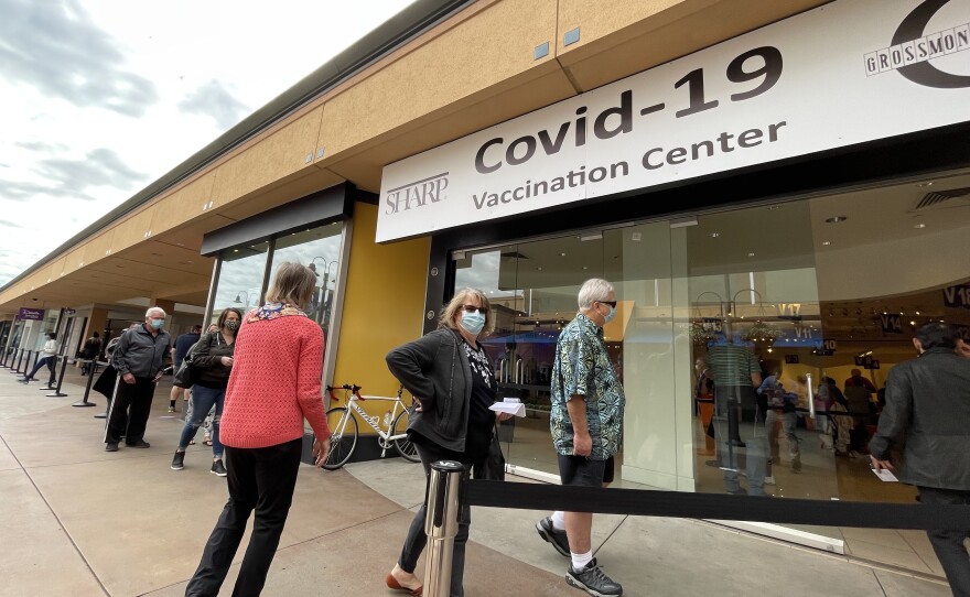 People wait outside the Grossmont Center vaccination super station in La Mesa, Feb. 2, 2021.