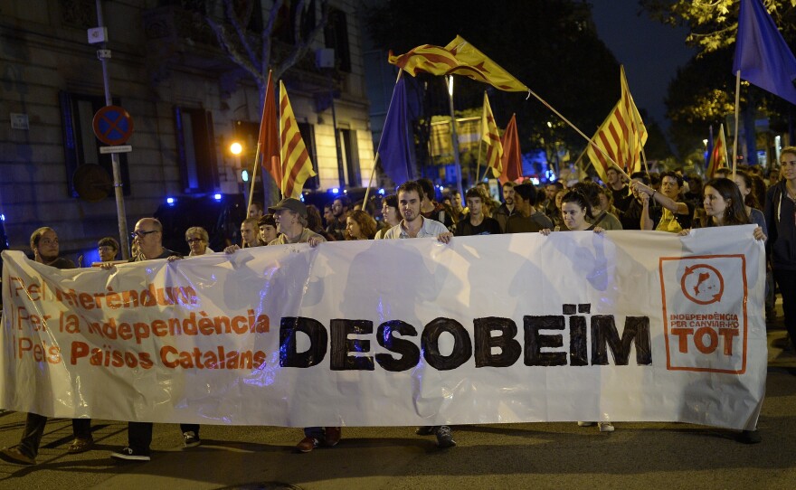 Pro-independence Catalans protest in front of a Spanish government delegation in Barcelona Monday, after Spain's Constitutional Court suspended an independence referendum called by Catalonia.
