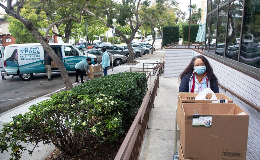 Fe Deguzman brings groceries in for residents at St. Paul's Manor in San Diego's Bankers Hill neighborhood, March 24, 2020.