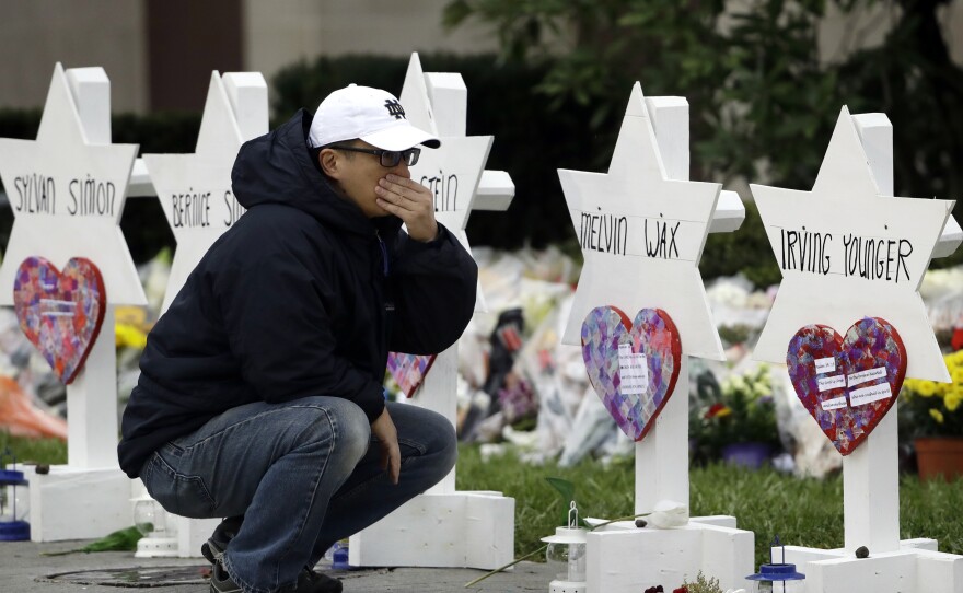 A person pauses in front of Stars of David with the names of those killed in a deadly shooting at the Tree of Life synagogue, in Pittsburgh, October, 29, 2018.