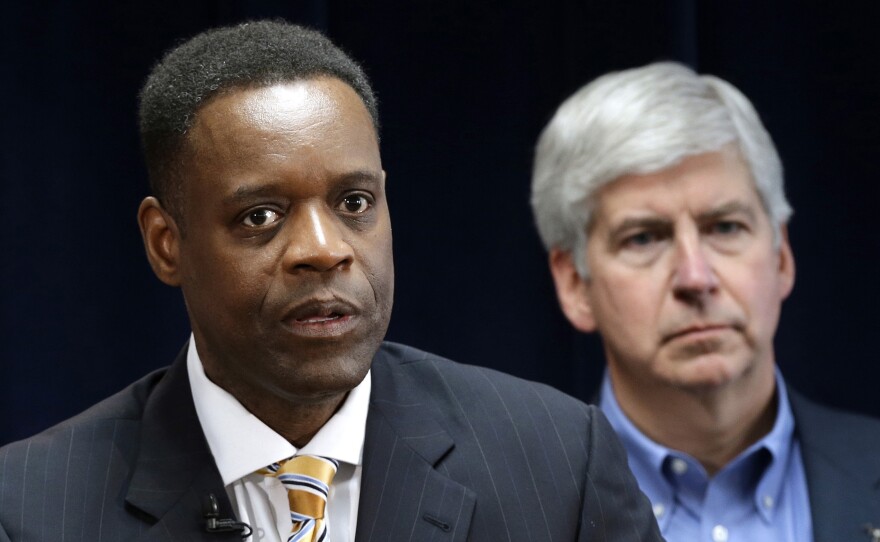Detroit emergency manager Kevyn Orr, left, speaks at a news conference in Detroit as Michigan Gov. Rick Snyder, who appointed Orr, listens. Orr's plan for the city to emerge from bankruptcy is being heard by a federal judge today.