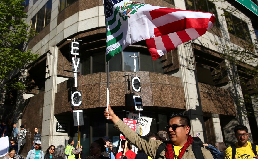 A former top attorney at ICE in Washington state has pleaded guilty to stealing the personal information of immigrants who were at risk of deportation and using the data to defraud banks. Here, protesters stand outside the ICE office in Seattle during a demonstration in May.