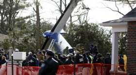 Workers clear debris from Continental Connection Flight 3407, which crashed Feb. 12, 2009, in Clarence, N.Y. The plane crashed as it approached the Buffalo airport, killing all 49 people on board and one on the ground.