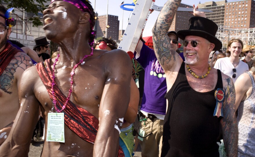 Dick Zigun (right) with a Mermaid Parade reveler. Zigun founded Coney Island's Mermaid Parade in 1983.