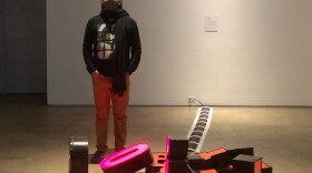 Artist Francisco Eme poses in front of one of his installations at his Spanglish show at the San Diego Art Institute in this photo taken in November, 2018.  