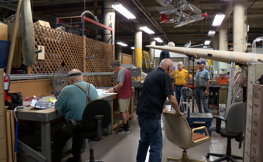 Volunteers are shown working on a replica of the Hughes H-1 Racer in the restoration shop of the San Diego Air & Space Museum on July 13, 2026.