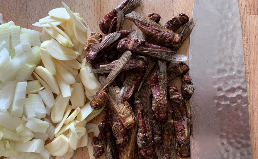 Onions, garlic and locusts being prepped for a dish by Brooklyn Bugs' chef Joseph Yoon. Undated photo.