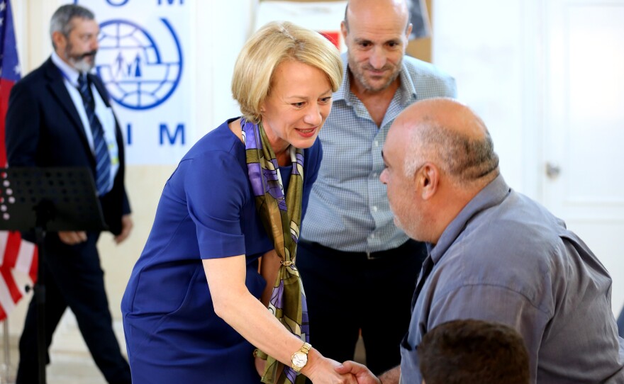 The U.S. ambassador to Jordan, Alice Wells, shakes hands with Syrian refugees Sunday ahead of their departure to the United States.