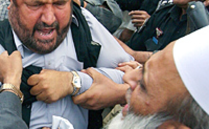 Former chief minister of Pakistan's North Western Frontier Province Pir Sabir Shah of the Pakistan Muslim League-Nawaz, center, is arrested during an anti-Musharraf demonstration in Peshawar.