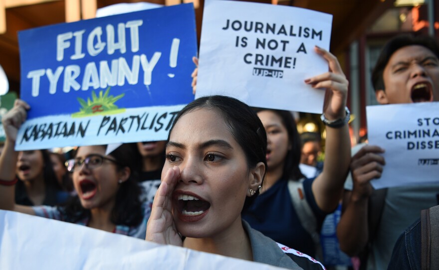 Students hold placards as they shout slogans during a protest at the state university in Manila, Philippines, on Thursday in support of Rappler CEO Maria Ressa, who was arrested a day earlier.