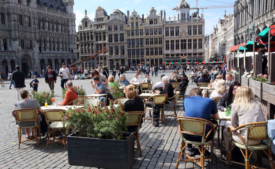 People enjoy the May sunshine from the cafe terraces of Brussels' Grand Place. On Friday, European Union added the United States to the list of countries whose citizens and residents should be allowed to travel freely within the bloc.