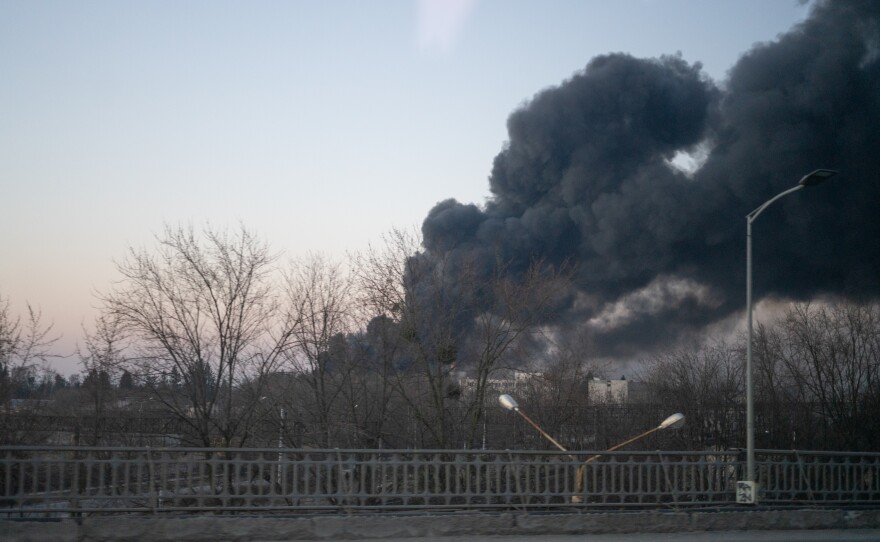 Smoke billows over a street near the airport in Lviv.