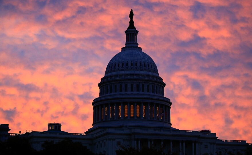 Filmmaker Ken Burns says America is "defined as much by our challenges and the dark moments as we are by our successes." Above, the sun rises behind the U.S. Capitol Building in Washington, D.C.