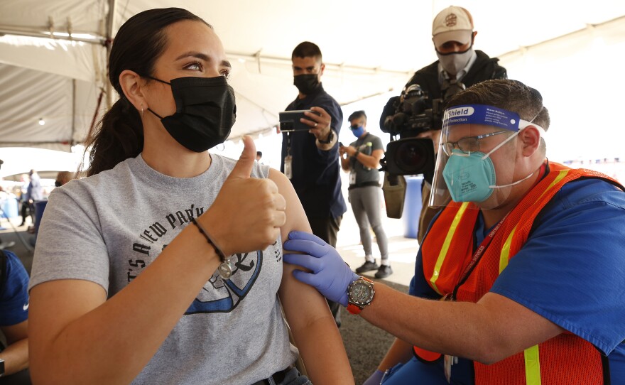 Miriam De La Torre, an intervention specialist with LAUSD Charter ICEF Public Schools receives her first COVID-19 Moderna vaccination, earlier this month. The LA Unified School District and the United Teachers LA union say they've reach a tentative agreement to return to in-person learning next month.