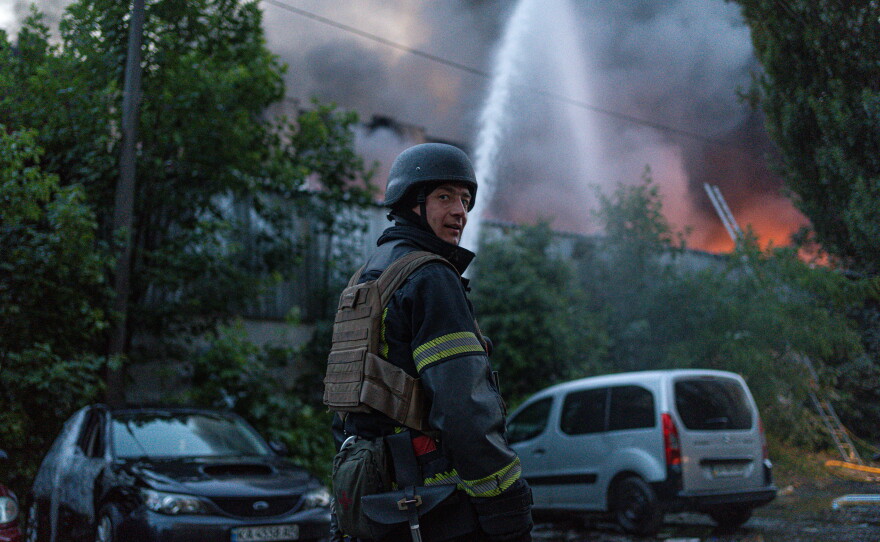 Firefighters put out flames after the attack.