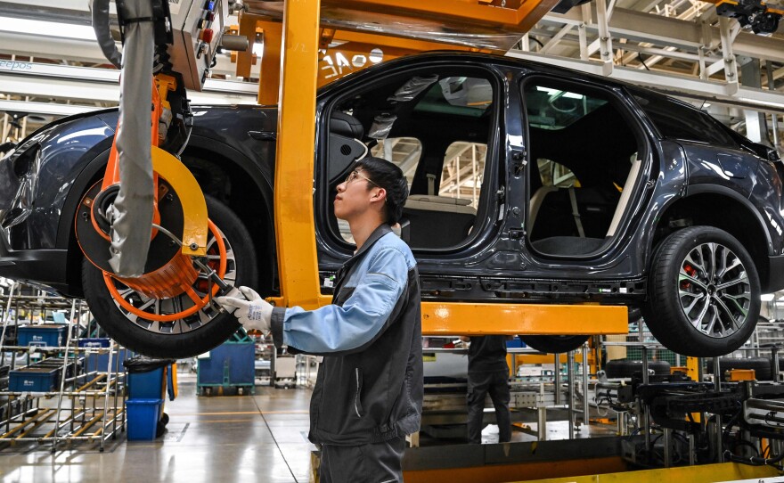 An employee works on a car along the assembly line at a factory of Chinese automaker NIO in Hefei, in China's eastern Anhui province on May 10, 2023. Like other Chinese automakers, Nio has big global ambitions.