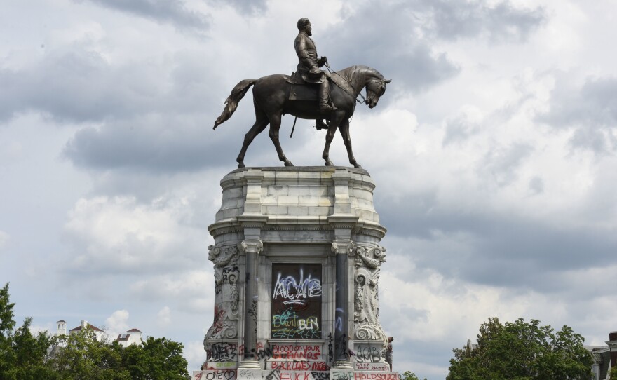 Protesters climb on the base of the statue of Confederate General Robert E. Lee on Monument Avenue on June 6, 2020 in Richmond, Virginia amid continued protests over the death of George Floyd in police custody. The statue is set to be taken down on Sept. 8, 2021.