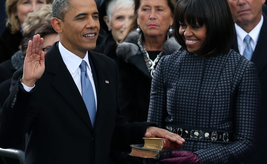 President Obama taking the oath of office today on the steps of the Capitol. First Lady Michelle Obama held the two Bibles on which he placed his hand.