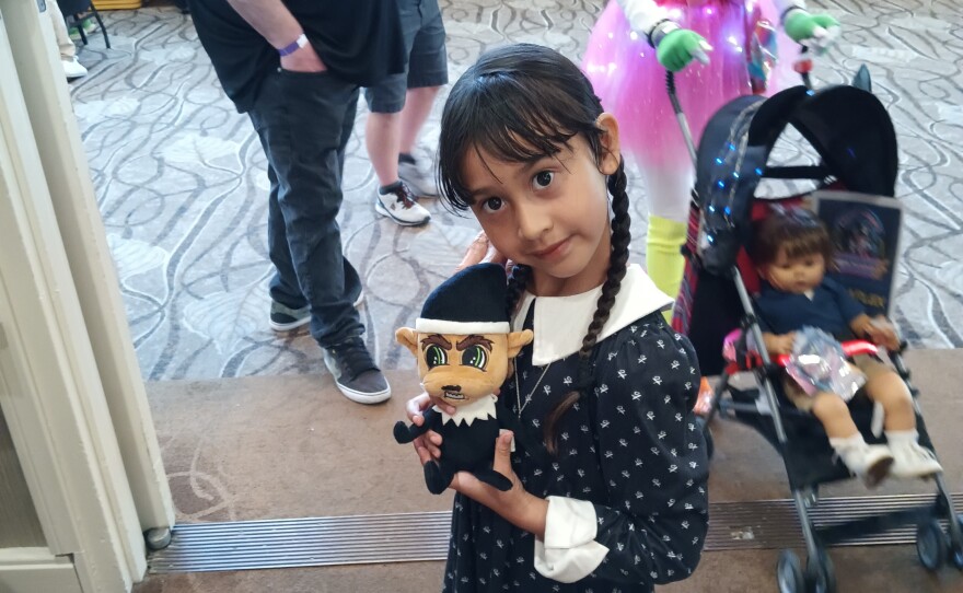 A young customer with one of Jennifer Cooksey's Creep in the Corner plushies at last year's Fright Mart. 