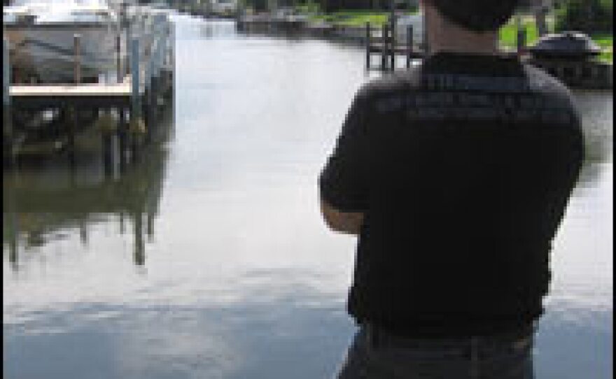 Bahjat, an Iraqi refugee, stands in the backyard of his new home in Cape Coral, Fla., a resort retirement community that's a stark contrast to life in Baghdad. His rent and food aid will soon run out and he hasn't found work.