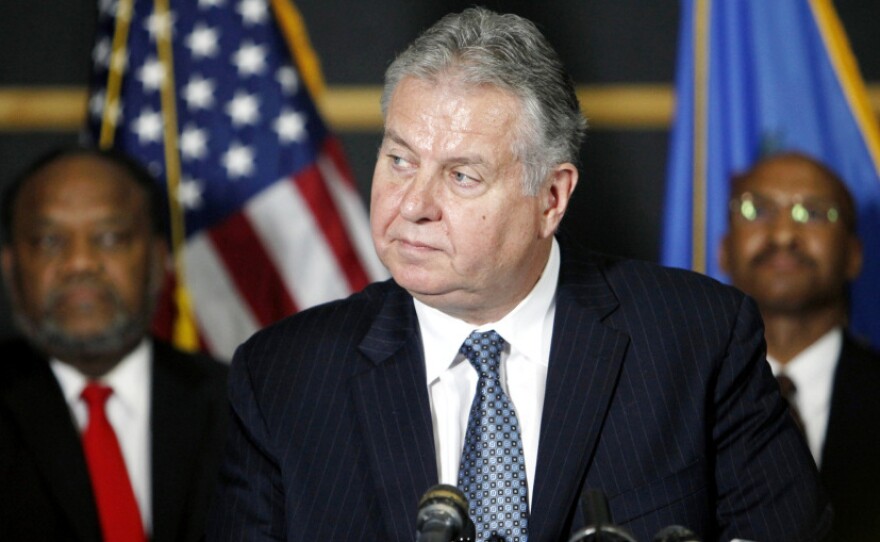 Tulsa Police Chief Chuck Jordan (center) speaks as City Councilor Jack Henderson (right) and FBI agent James Finchother listen during a news conference on Sunday in Tulsa, Okla.