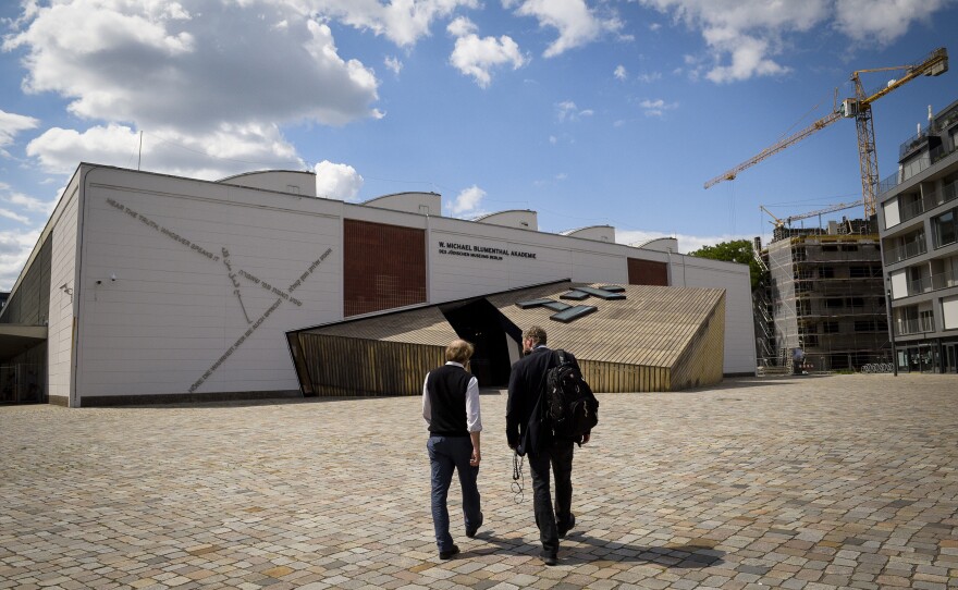 Aubrey Pomerance walks with Uri to the archives across the street from the Jewish museum.
