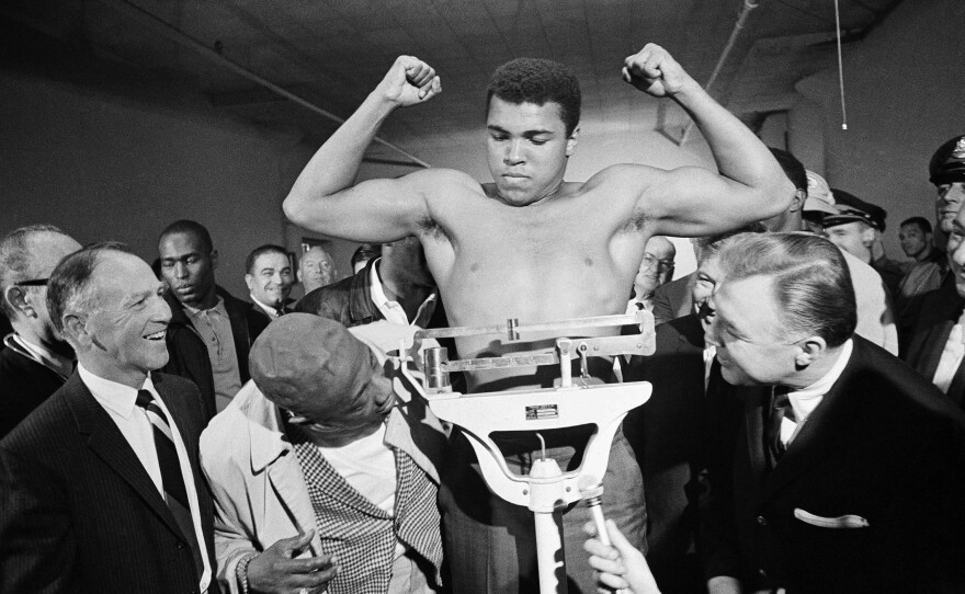 Boxer Muhammad Ali weighs in a week before his heavyweight bout with Jerry Quarry on Oct. 20, 1970 in Atlanta. Ali died at 74.