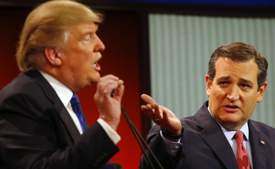 Donald Trump and Ted Cruz argue a point during a Republican presidential primary debate in Detroit, March 3, 2016.