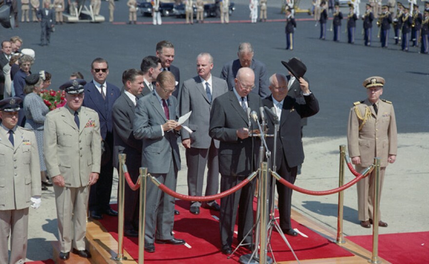 Soviet Premier Nikita Khrushchev speaks on arrival at Andrews Air Force Base, Md., Sept 15, 1959. On platform with him are (r-l) President Eisenhower, Sec. of State Christian Herter; Soviet Amb. to UN and an interpreter (in front of Lodge). Others unidentified.