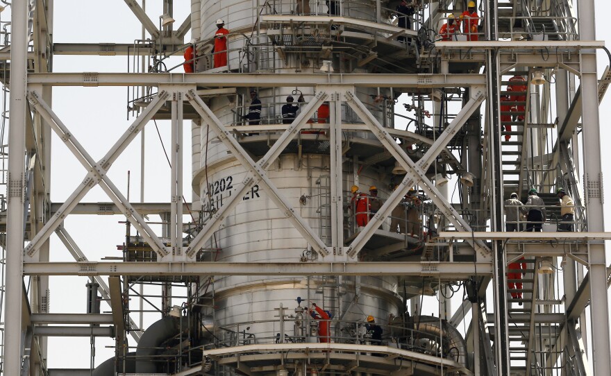 Workers fix damage at Saudi Aramco's Khurais oil field in Saudi Arabia on Friday after it was hit during a Sept. 14 attack.