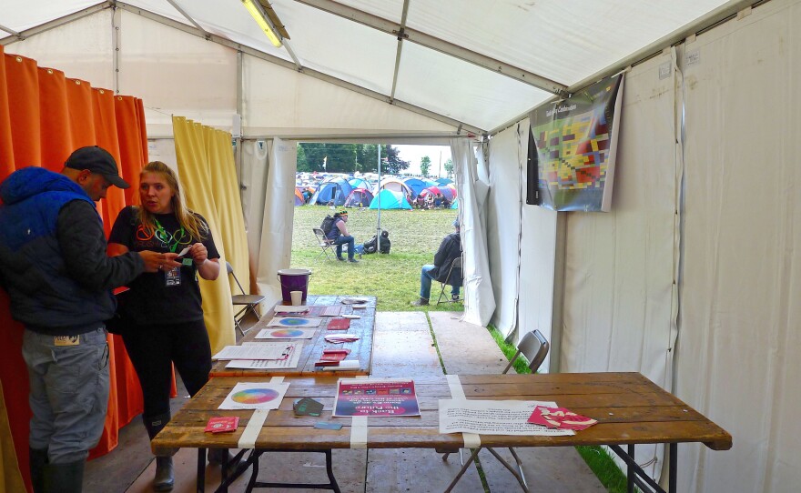 Rio Brown (left) gets advice from drug counselor Gemma Bennet inside a drug testing and information tent at Kendal Calling. A nonprofit, The Loop, set up the tent to test partiers' illegal drugs before they take them.